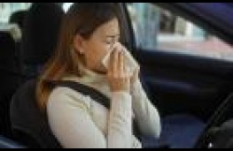 Female driver sneezing